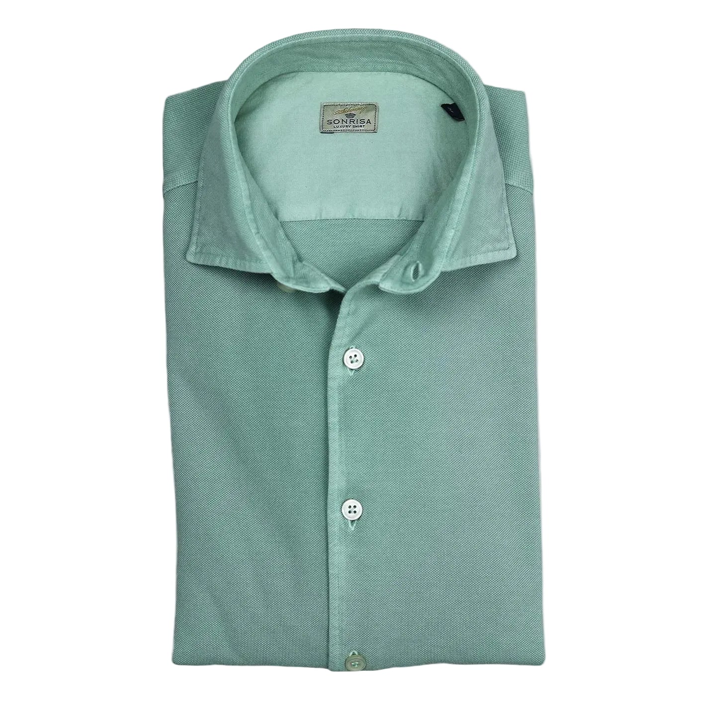 Folded green shirt with a brand label on a white background